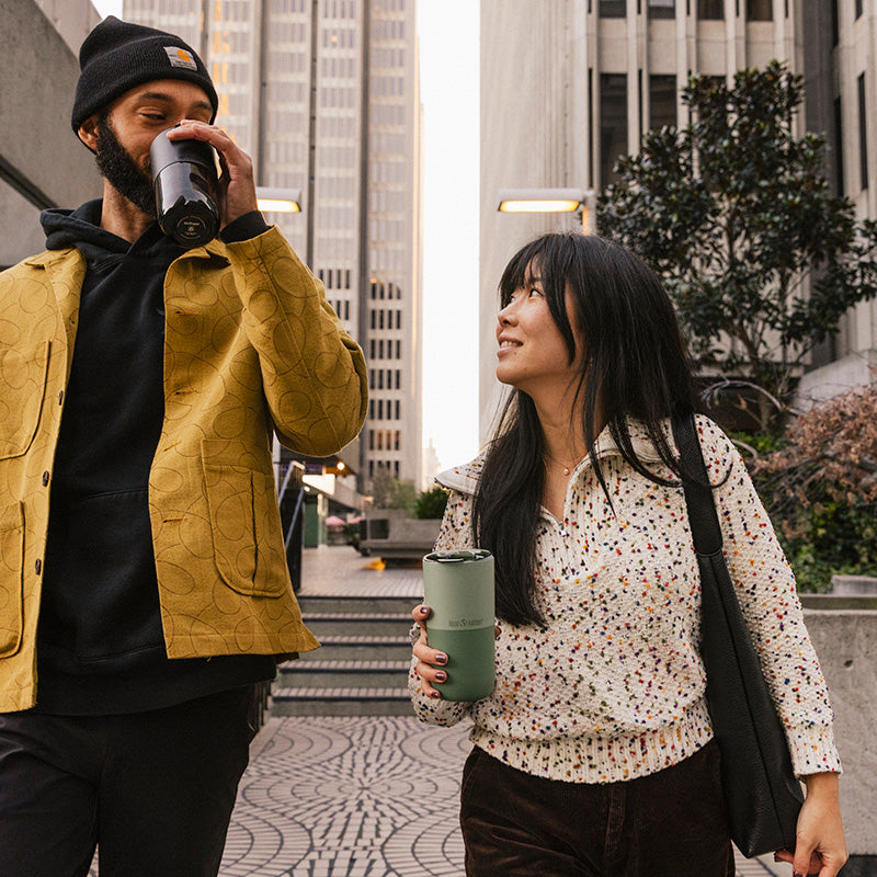 16oz-rise-tumbler-b4 16oz_rise_tumbler_black_iceberg_couple_drink_city_street_square.jpg