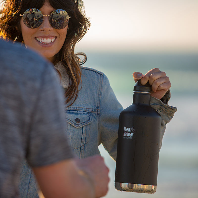 64oz-classic-with-loop-cap-p8 64oz_insulated_classic_black_beach_girl_hand_square.jpg