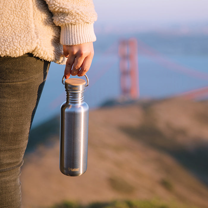 27oz-reflect-with-bamboo-cap-a6 K27SSLRF-BS-BAMBOO_reflect_bottle_bridge_lifestyle.jpg